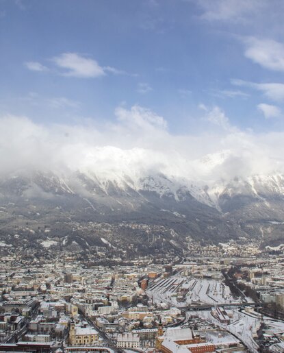 Innsbruck under snow with mountain panorama and blue sky